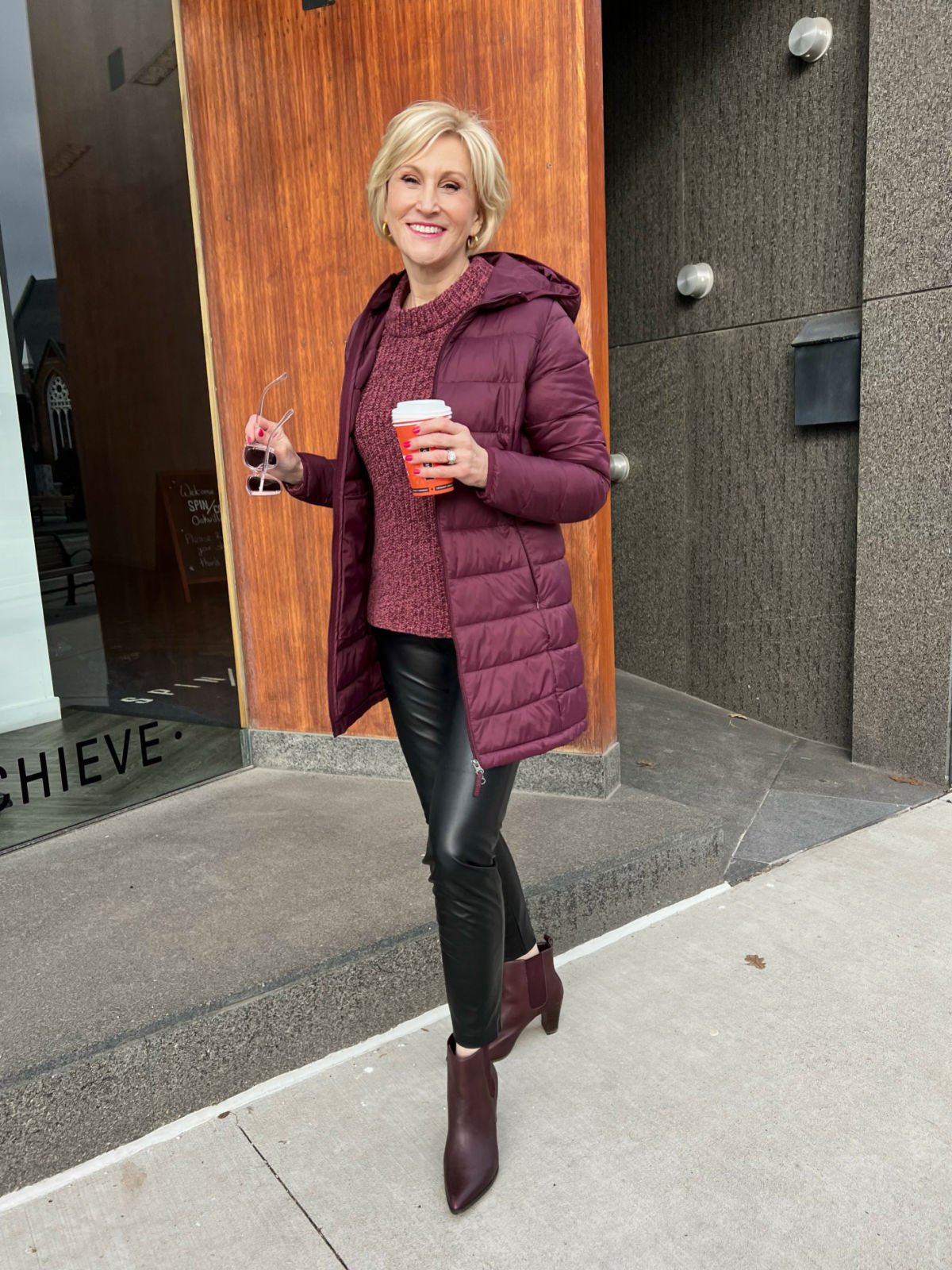 what to wear to a winter concert - burgundy puffer jacket, black faux leather pants