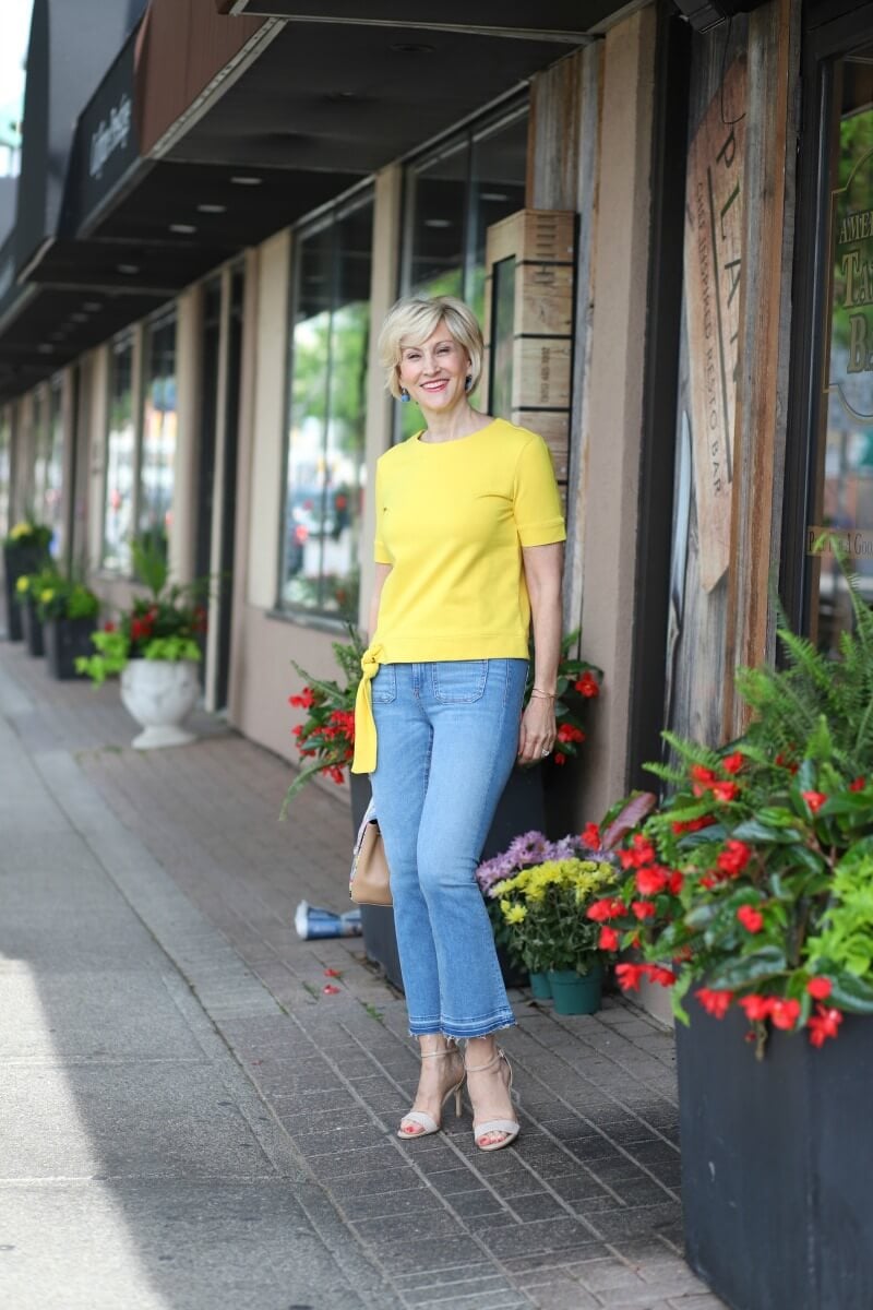 Style Blogger Deborah Boland Style of Fabulous After 40 wears Veronica Beard Cropped Flare Jeans with large front pockets and a yellow top