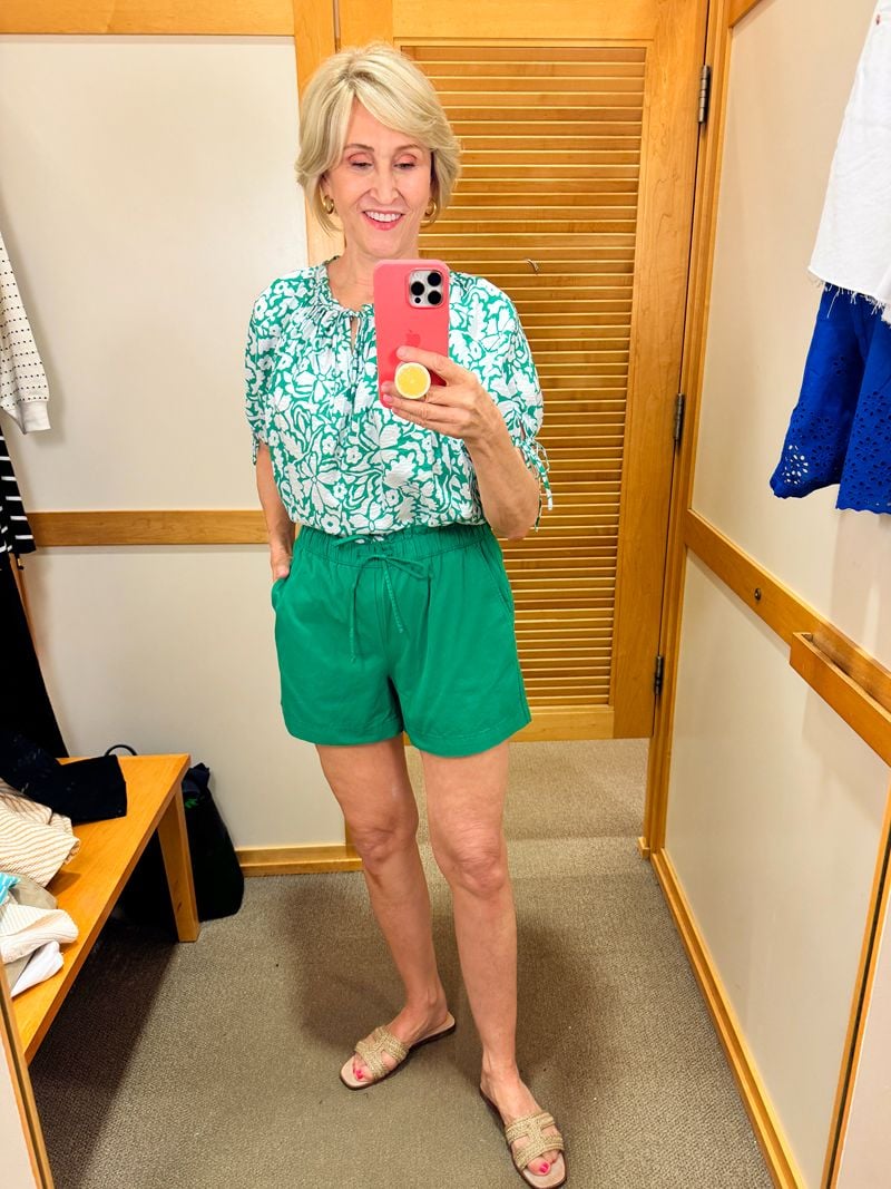 green shorts, green and white top