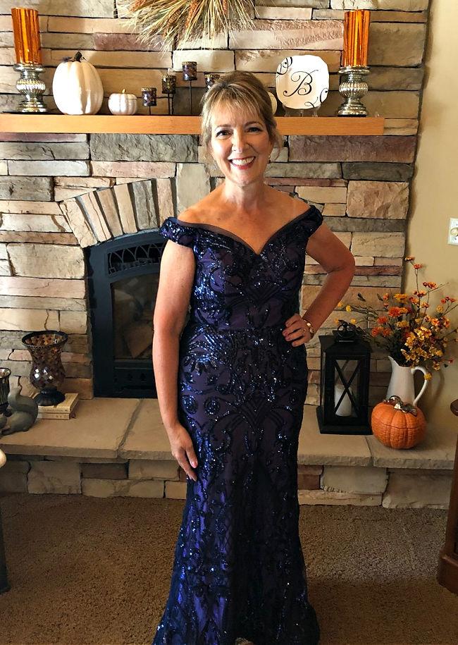 Linda-Bailey-wearing blur, sparkle, off the shoulder navy Mother of the Bride dress